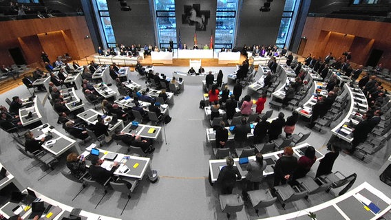 Abgeordnete stehen während der Abstimmung zum Haushalt 2024 im Plenarsaal des niedersächsischen Landtag auf. © NDR 