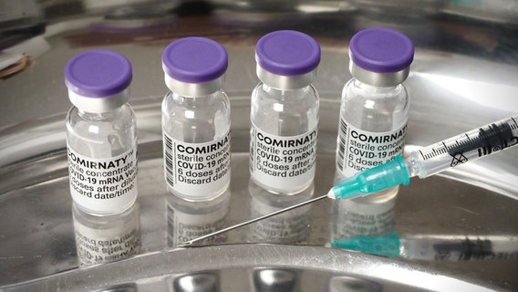 Fläschchen mit dem Corona-Impfstoff Comirnaty von Biontech/Pfizer stehen in einer Arztpraxis. © dpa Foto: Soeren Stache