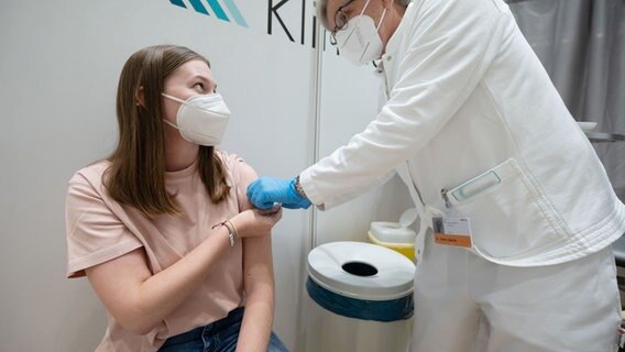 Ein Arzt gibt einer jungen Frau eine Covid-19 Impfung. © picture alliance/dpa/Marijan Murat Foto: Marijan Murat