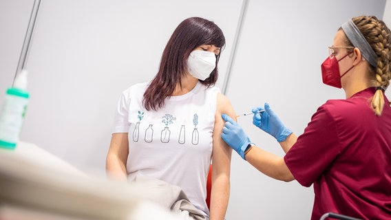 Eine Frau bekommt von einer Gesundheits- und Krankenpflegerin eine Corona-Schutzimpfung mit dem Impfstoff von Biontech/Pfizer verabreicht. © picture alliance/dpa Foto:  Moritz Frankenberg
