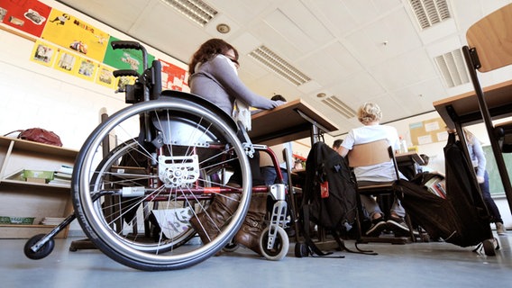 Eine Schülerin sitzt in einem Rollstuhl in einem Klassenzimmer. © dpa-Bildfunk Foto: Holger Hollemann