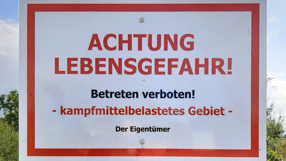 Ein Schild warnt vor dem Betreten eines mit Kampfmittel belasteten Gebiets. © picture alliance/blickwinkel Foto: M. Henning
