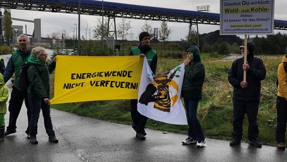 Demonstranten stehen mit Transparenten vor einem Kraftwerk. © NDR Foto: Jutta Przygoda