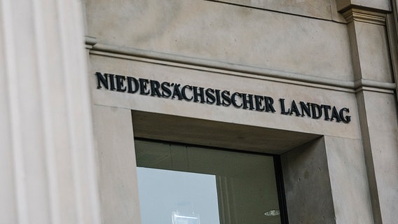 Über einer Glasscheibe steht die Aufschrift Niedersächsischer Landtag. © NDR Foto: Julius Matuschik
