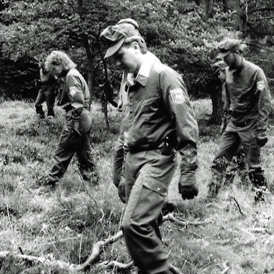 Polizisten suchen nach Spuren in einem Wald. © NDR 