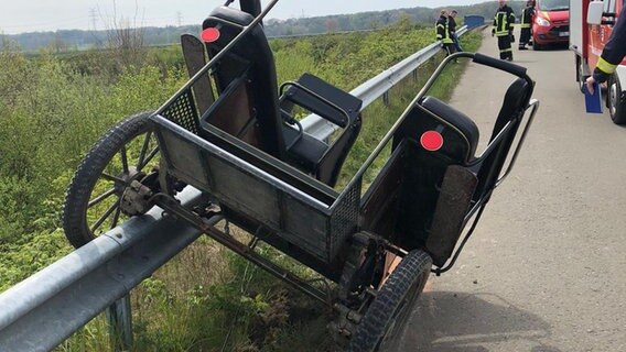 Eine Pferdekutsche hängt mit einem Rad auf einer Leitplanke. © Polizeiinspektion Stade 