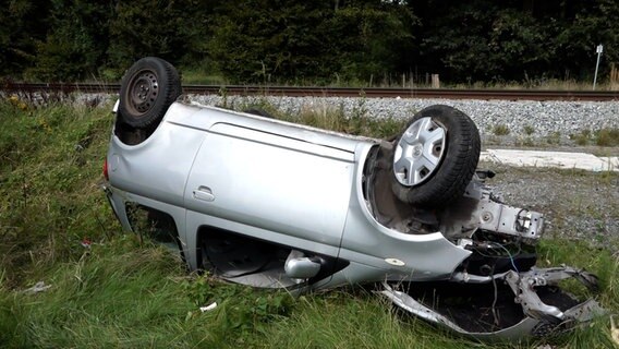 Ein Auto liegt nach einem Unfall an einem Bahnübergang in Oldenburg auf dem Dach. © tv7news 
