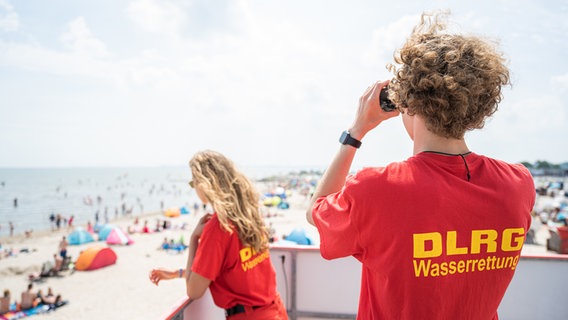 Die ehrenamtliche Rettungsschwimmerin Xenia und ihr Kollege Luca überwachen einen Badestrand an der Nordsee bei Schillig. © dpa/picture alliance Foto: Mohssen Assanimoghaddam