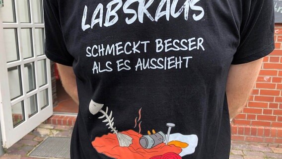 Eine Frau trägt ein T-Shirt mit der Aufschrift "Labskaus schmeckt besser als aussieht". © NDR Foto: Jutta Przygoda