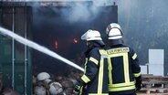 Feuerwehrleute löschen eine brennende Halle in Oyten. © Nord-West-Media TV 