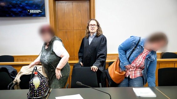 Zwei angeklagte Frauen betreten einen Gerichtssaal. © dpa Foto: Sina Schuldt