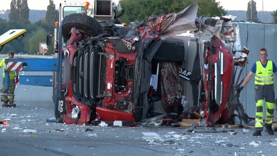 Ein Lkw liegt nach einem Unfall auf der Seite auf einer Autobahn. © Nord-West-Media TV 