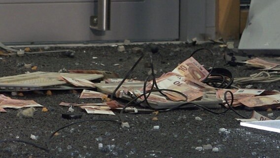 Money lies on the floor of a bank. © Nonstopnews
