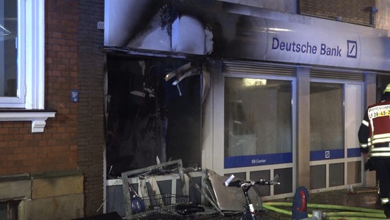 The entrance of a "German bank" is badly damaged.