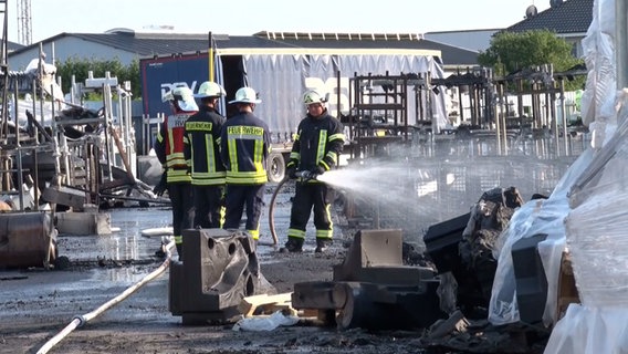 Feuerwehrleute löschen einen Brand auf einem Firmengelände. © Nord-West-Media TV 