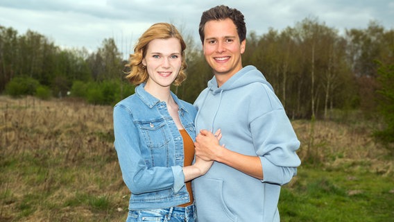 Actors Lucy Hellenbrecht and Lucas Bauer stand for a period of the series 