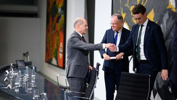 Bundeskanzler Olaf Scholz zusammen mit den Ministerpräsidenten Stephan Weil und Hendrik Wüst bei einer Pressekonferenz. © Bernd von Jutrczenka/dpa Foto: Bernd von Jutrczenka