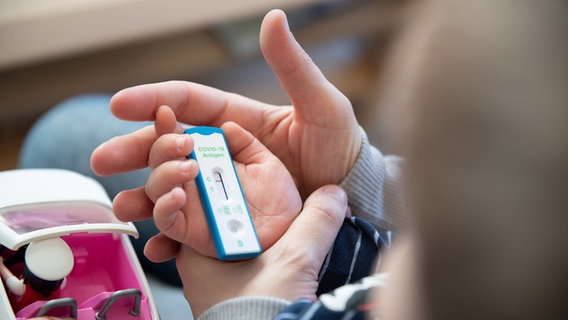 Ein Kind hält einen Coronatest in der Hand. © dpa-bildfunk Foto: Friso Gentsch