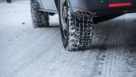 Ein Auto steht auf einer schneebedeckten Straße. © picture alliance/Fotostand Foto: Fotostand/K. Schmitt