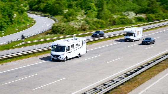 Wohnmobile und Autos fahren am Kreuz Lübeck auf der Autobahn A1. © picture alliance Foto: Jonas Walzberg