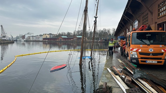 Die Masten eines gesunkenen Traditionsschiffes ragen aus dem Wasser im Lübecker Hafen. © NDR 