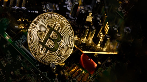 Eine physische Bitcoin-Münze liegt auf Schaltkreisen. © picture alliance Foto: CHROMORANGE | Michelangelo Oprandi