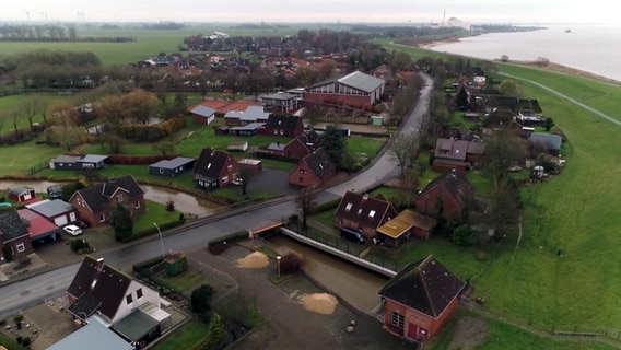 Ein Luftaufnahme zeigt das Panorama von Brokdorf mit dem AKW am Horizont. © NDR 