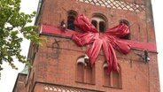 Eine rote Schleife ziehrt den Lübecker Dom zum 850. Geburtstag. © NDR 