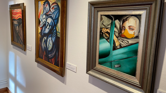 Drei Bilder, die berühmte Werke mit Enten im Stil von Donald Duck nachempfinden, hängen an einer Wand des Museum und Stiftung Landdrostei in Pinneberg im Rahmen der Wanderausstellung Duckomenta. © NDR Foto: Jonas Hanst