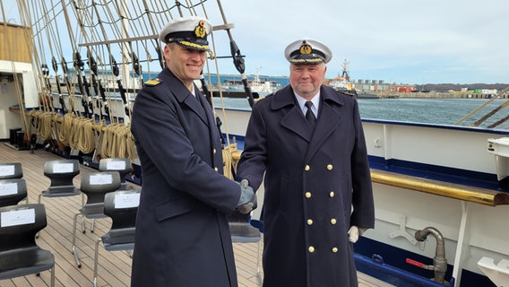 Kapitän zur See Nils Brandt (rechts) und Kapitän zur See Andreas-Peter Graf von Kielmansegg geben sich die Hand.  Foto: Kai Peuckert