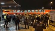 Viele Personen stehen zwischen mehreren Polizeibeamten an einem Bahnhof. © Timo Jann Foto: Timo Jann