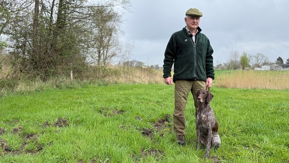 Kreisjägermeister Horst Bröge mit Hund Timba auf einer Lichtung auf Holnis. Kreisjägermeister Horst Bröge mit Hund Timba auf einer Lichtung auf Holnis. © NDR Foto: Jörn Zahlmann