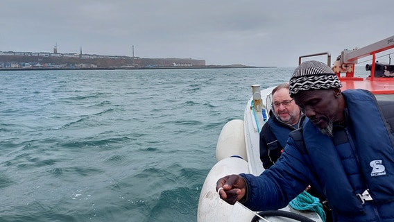 Two men on a research vessel on the water.  © Laura Albus Photo: Laura Albus