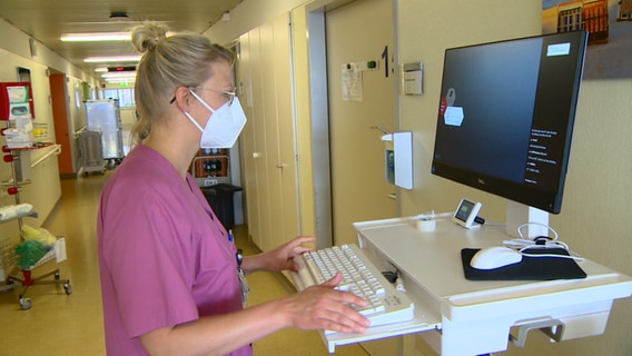 Eine Krankenschwester gibt etwas in einen Computer ein. © NDR 