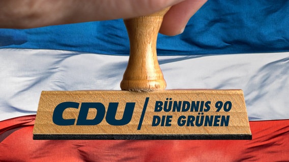 Ein Stempel trägt die Aufschrift CDU und Grüne. © Picture Alliance 