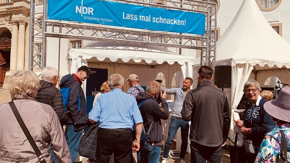 Menschen stehen an einem Stand des NDR: Autogrammstunde mit Gerrit Derkowski.  Foto: Karin Hausschildt