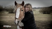 Eine Frau umarmt ihr Pferd. © NDR 