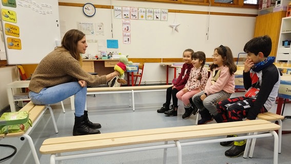 Eine Lehrerin unterrichtet Kinder mit einer Handpuppe. © NDR Foto: Judith Pape