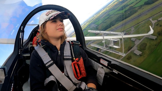 Laura Gärtner sitzt im Cockpit eines Segelfliegers und segelt über Nordfriesland. © NDR 