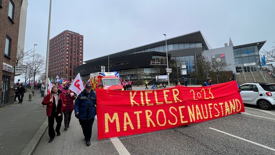 Mehrere Menschen mit Transparenten bei einem Warnstreik in Kiel. © Tobias Gellert Foto: Tobias Gellert