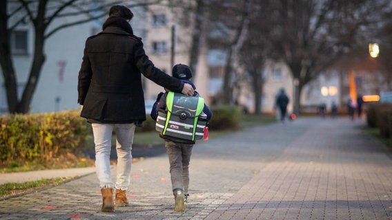Ein Vater und sein Sohn gehen zur Schule. © dpa-Bildfunk Foto: Frank Rumpenhorst