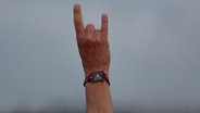 Eine Hand zeigt den Wacken-Gruß. © NDR Foto: Dominik Dührsen