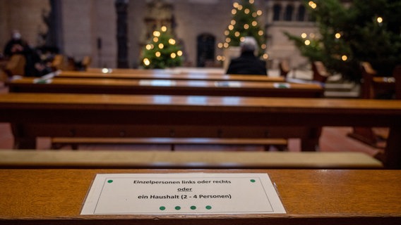 Ein Schild weist beim Pontifikalamt zu Weihnachten im Dom auf die Corona-Abstandsregeln hin. © picture alliance/dpa Foto: Harald Tittel