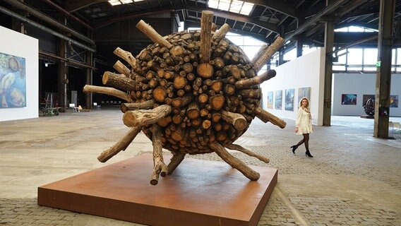 Ausstellungsmoderatorin Hanna Kremp geht an der Installation "2.25x" von Künstler Urs-P. Twellmann (Schweiz) in einer Halle der NordArt vorbei.  Foto: Marcus Brandt