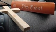 Symbol Kreuz und Bibel © dpa 