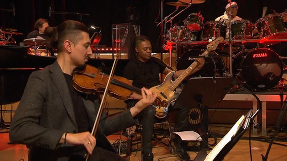 Die NDR Bigband und Geiger Adam Bałdych spielen beim Konzert "Fusion Conclusion". © NDR Bigband Foto: Screenshot