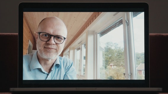 Geir Lysne, Chefdirigetn der NDR Bigband, schaut lächelnd in die Kamera. © NDR Foto: Screenshot NDR