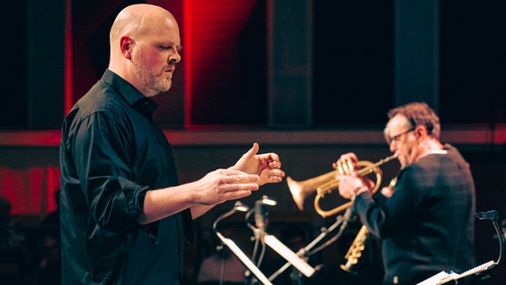 Dirigent Jörn Marcussen-Wulff auf der Bühne beim Presiträgerkonzert vom Landeswettbewerb "Jugend jazzt" im Rolf-Liebermann-Studio mit der NDR Bigband. © NDR Foto: Peer Bothmer