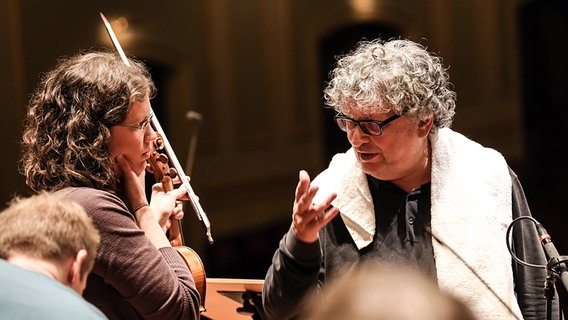 In der Probenpause: René Jacobs im Gespräch mit einer Geigerin des Helsinki Baroque Orchestra  Foto: Marcus Krüger