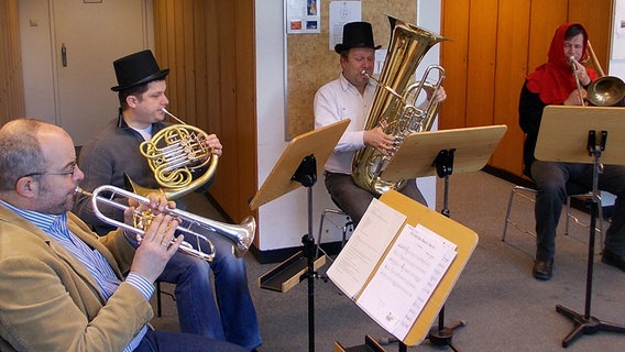 Vier Blechbläser mit Hüten auf dem Kopf bei einer Probe © NDR Sinfonieorchester 